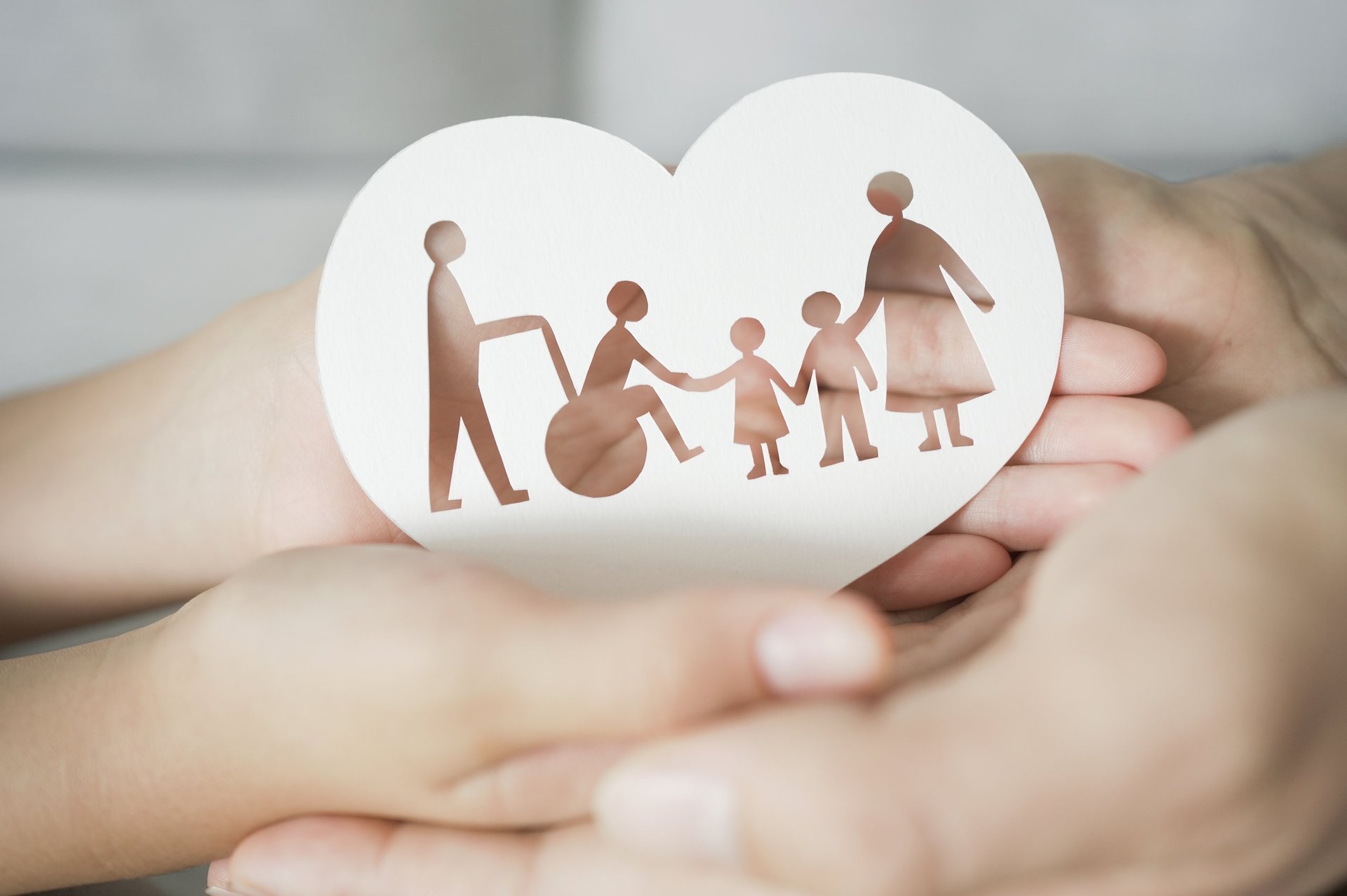 Hands holding diversity family